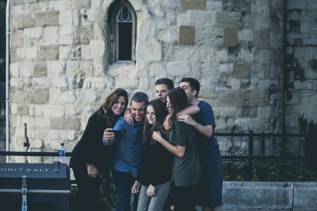 Group of friends enjoying a moment together outdoors near a historic building